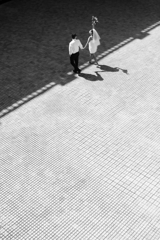 two people walk together along a paved walkway