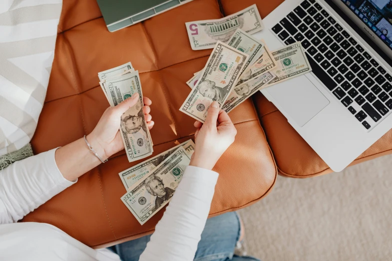 a woman on a couch playing with money