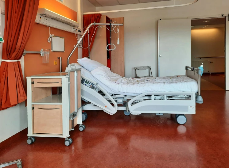 a hospital bed sitting in a room next to a wall