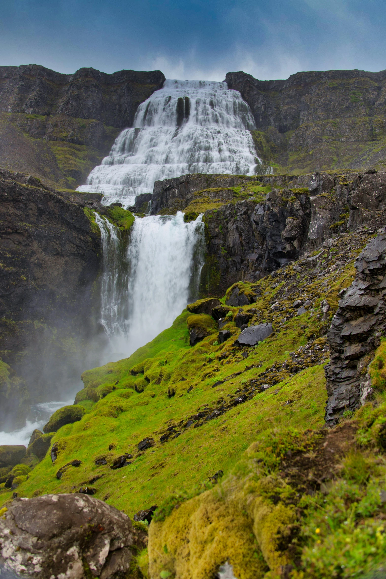 a waterfall flowing into the ocean from above it