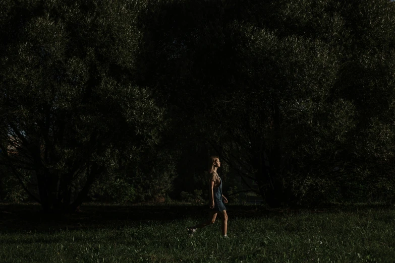 a person is standing in the dark near some trees