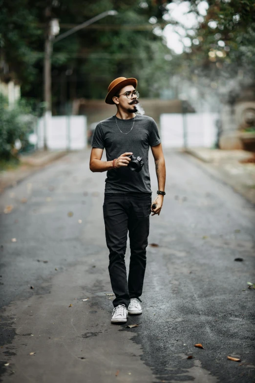 a man standing on a street corner with a camera