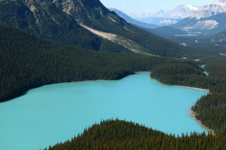 blue water sits in front of some mountains