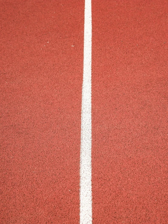 an orange tennis court with white line on it