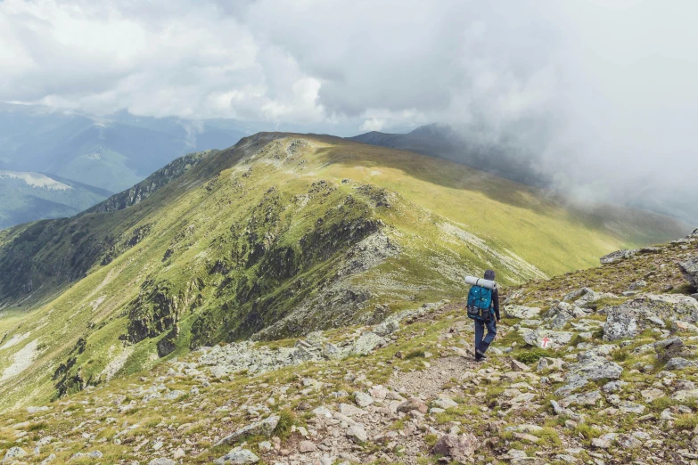 a man trekking up the side of a rocky cliff