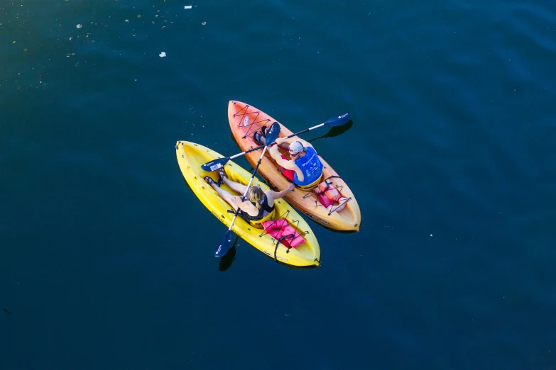 two people are in canoes on the water