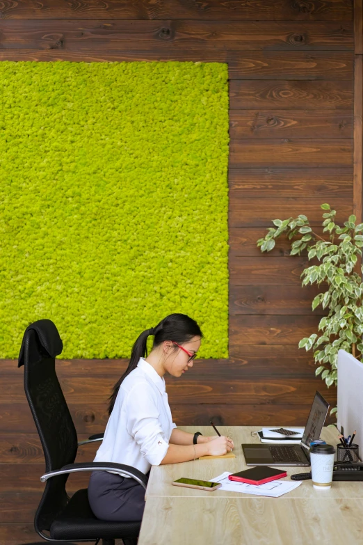 an asian lady is working at her desk