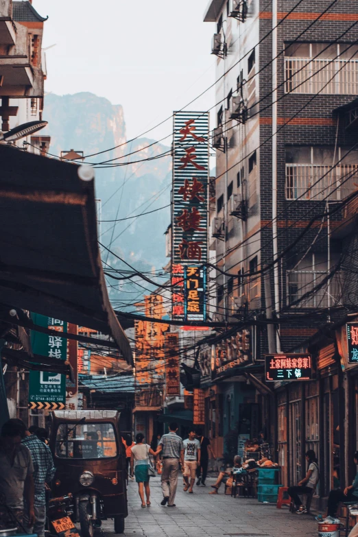 a couple of people walking on a street