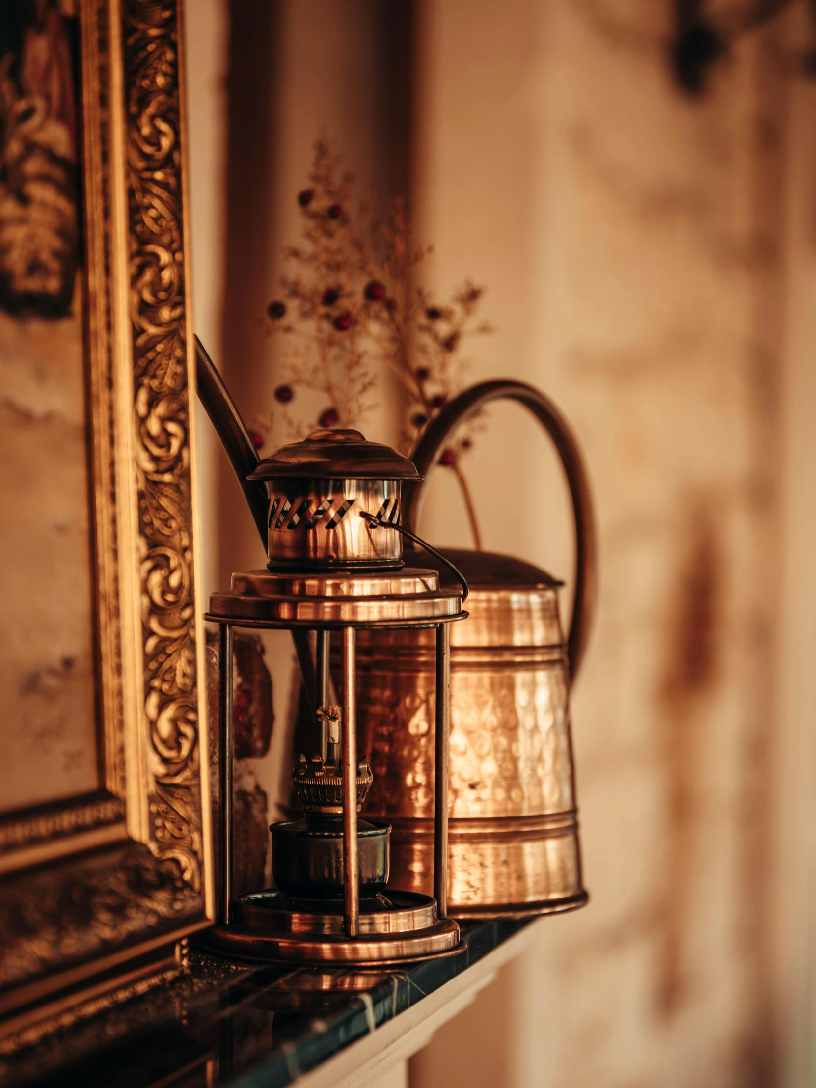 an old antique tea kettle on a mantle with a wall painting