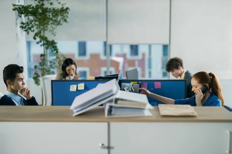 two women and two men work in an office