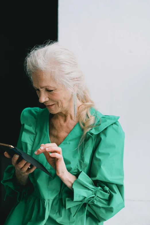 an elderly woman holding up a piece of metal