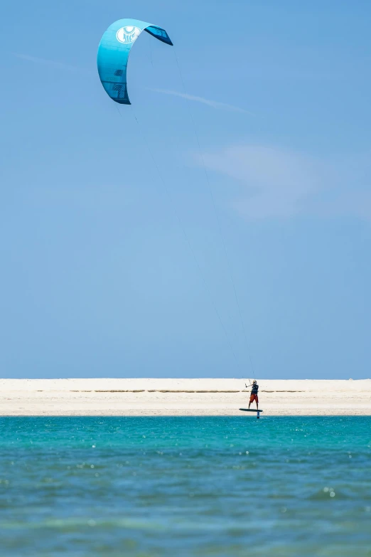 someone is riding the beach with the sails off