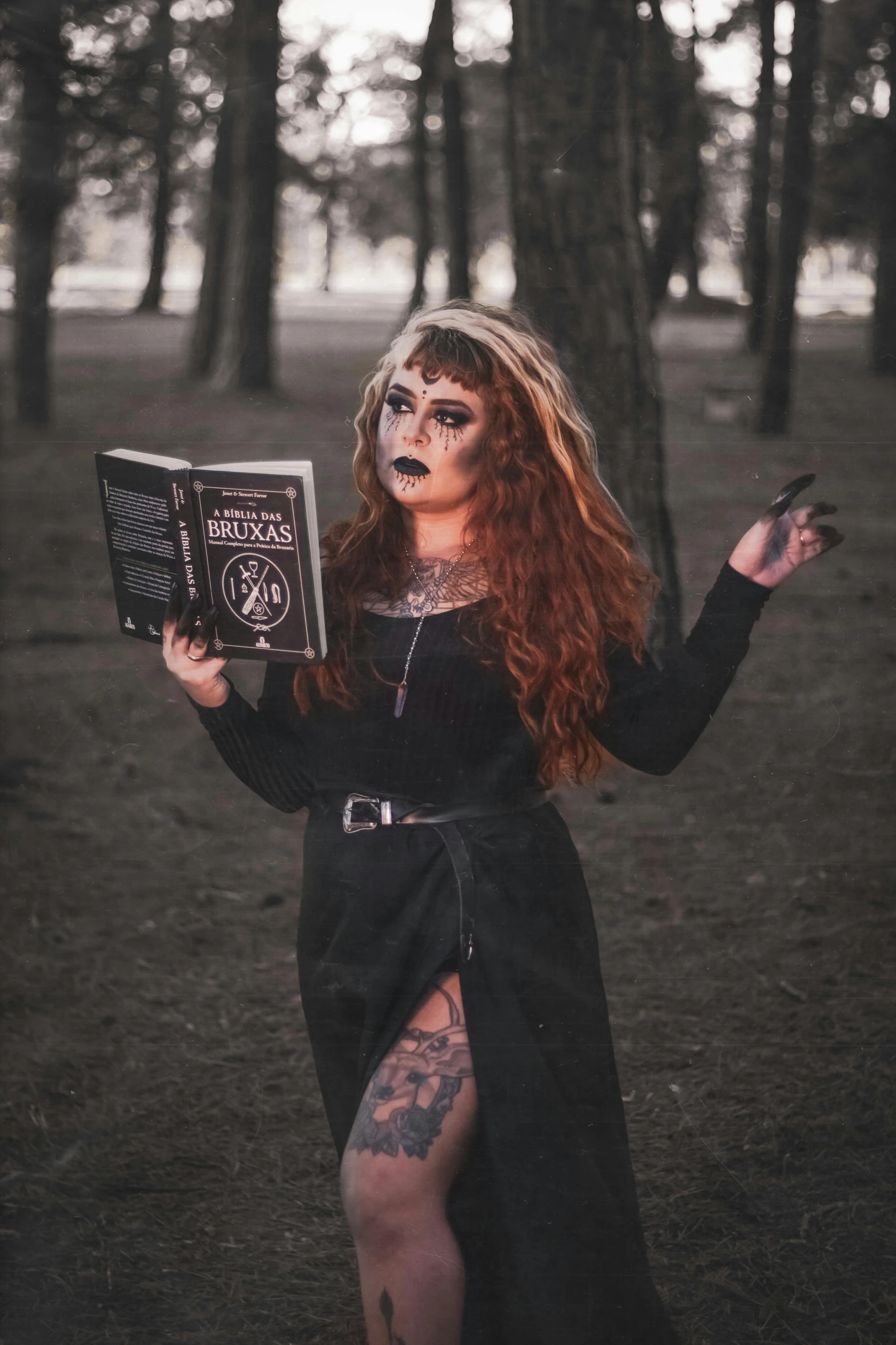 a woman wearing an elaborate dress and holding a book