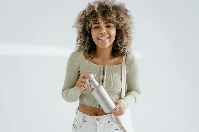 a person holds a water bottle in their hands