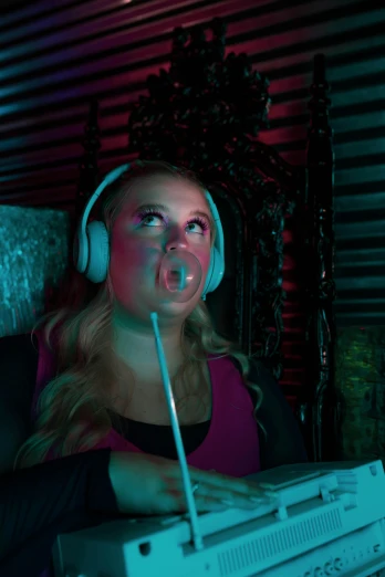 a girl wearing headphones and holding a pair of head phones