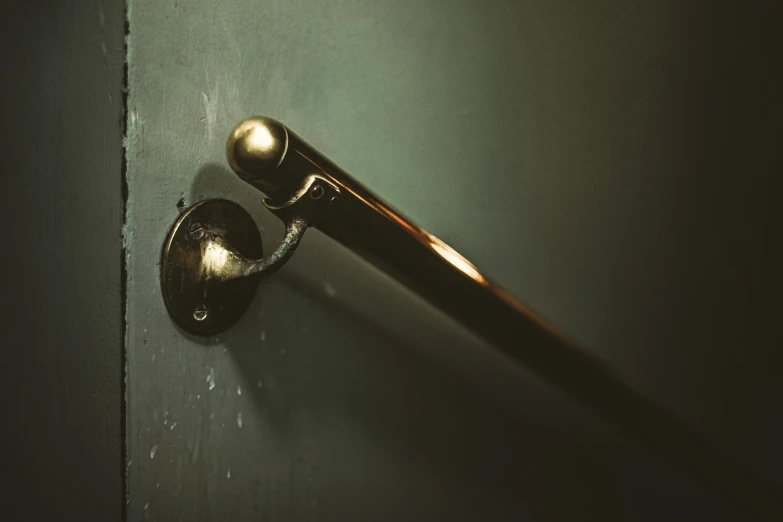 a dark colored door  with a shiny black door handle