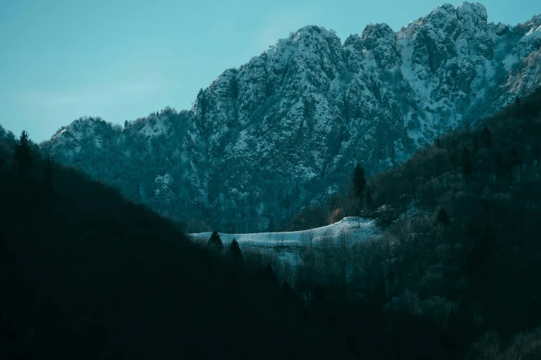 the mountain range is covered in lots of snow