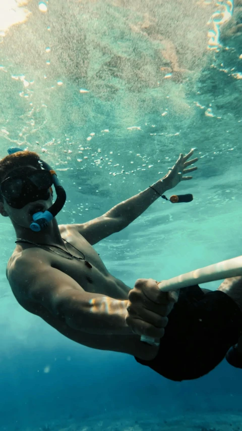 a girl is wearing black shorts under the water