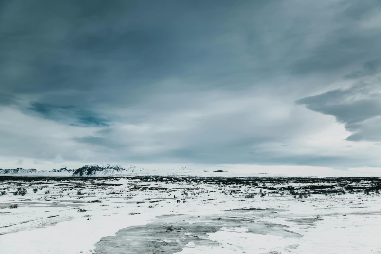 a very cloudy sky with clouds above the snow