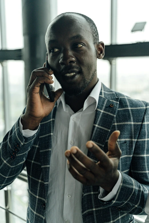 man making a gesture while on the phone