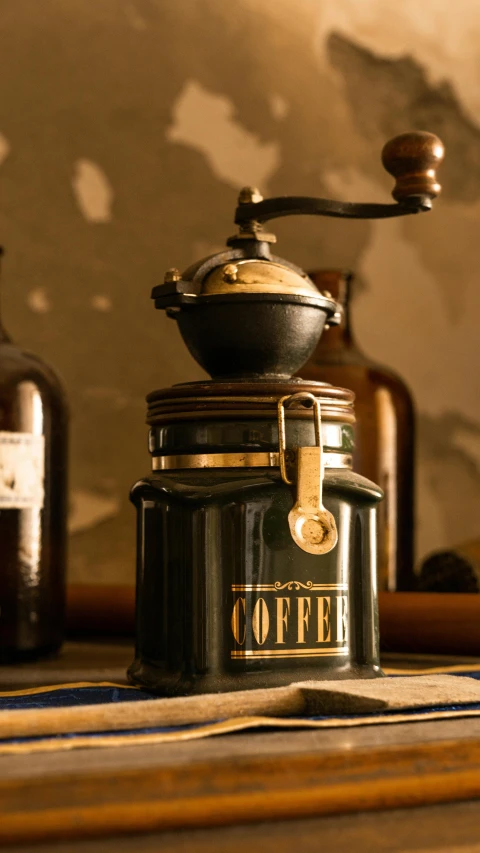 an old fashioned coffee grinder and other coffee makers