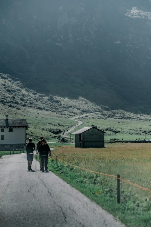 a man and woman are walking down the road