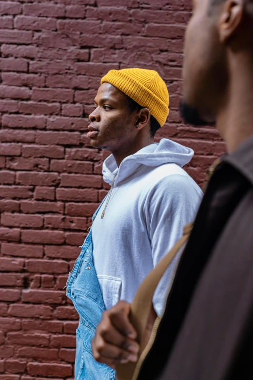 a young man wearing a blue shirt and a yellow hat