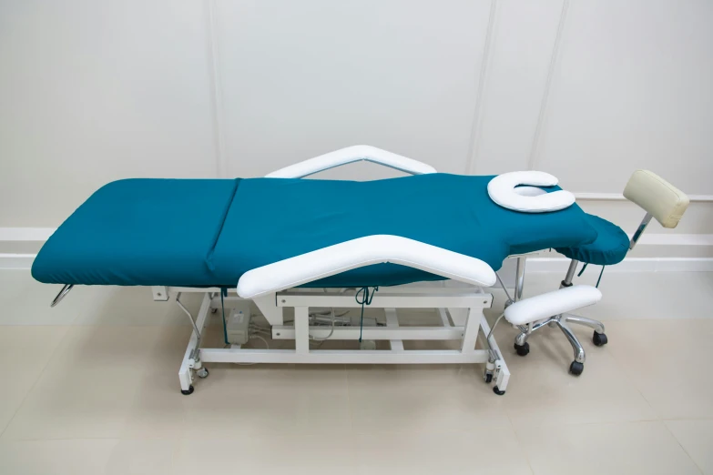 an exam table set up to receive patients a bed