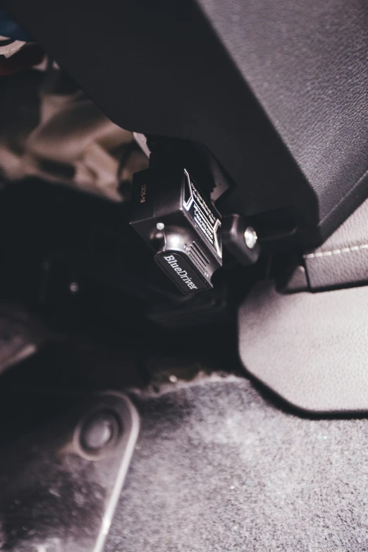 a po looking under the seat of an automobile