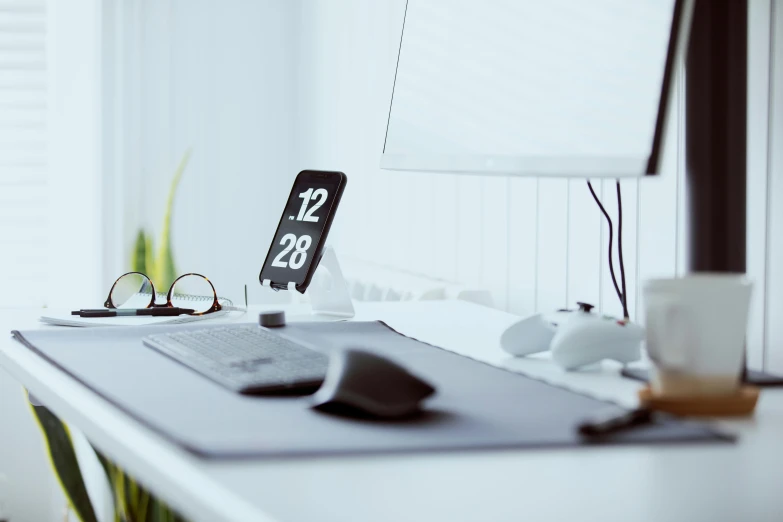 a white desk holding a mouse and other electronic accessories