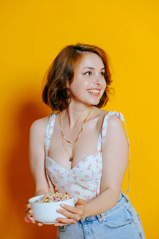 a woman holding up a bowl of cereal