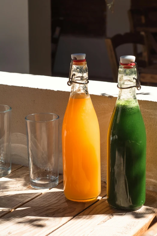 two drinks in front of some glass bottles