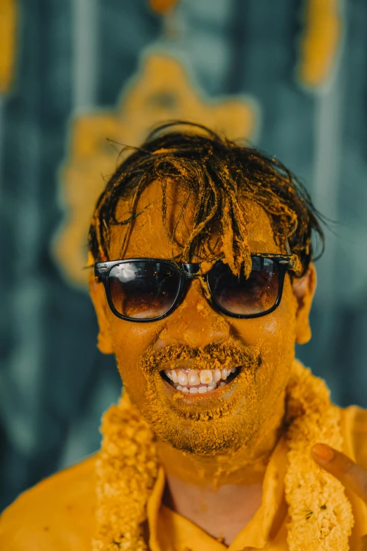 a man with a yellow jacket and sunglasses on