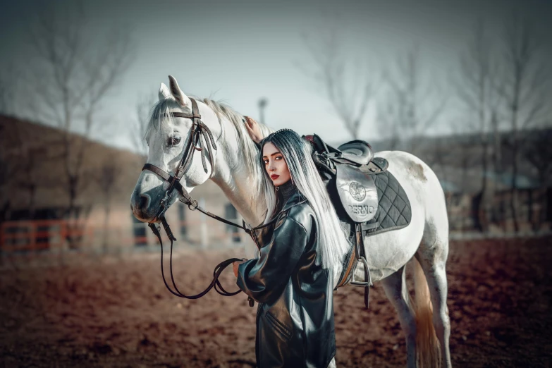 woman in leather outfit with a white horse