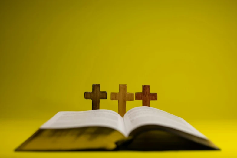 a po of two crosses and an open bible