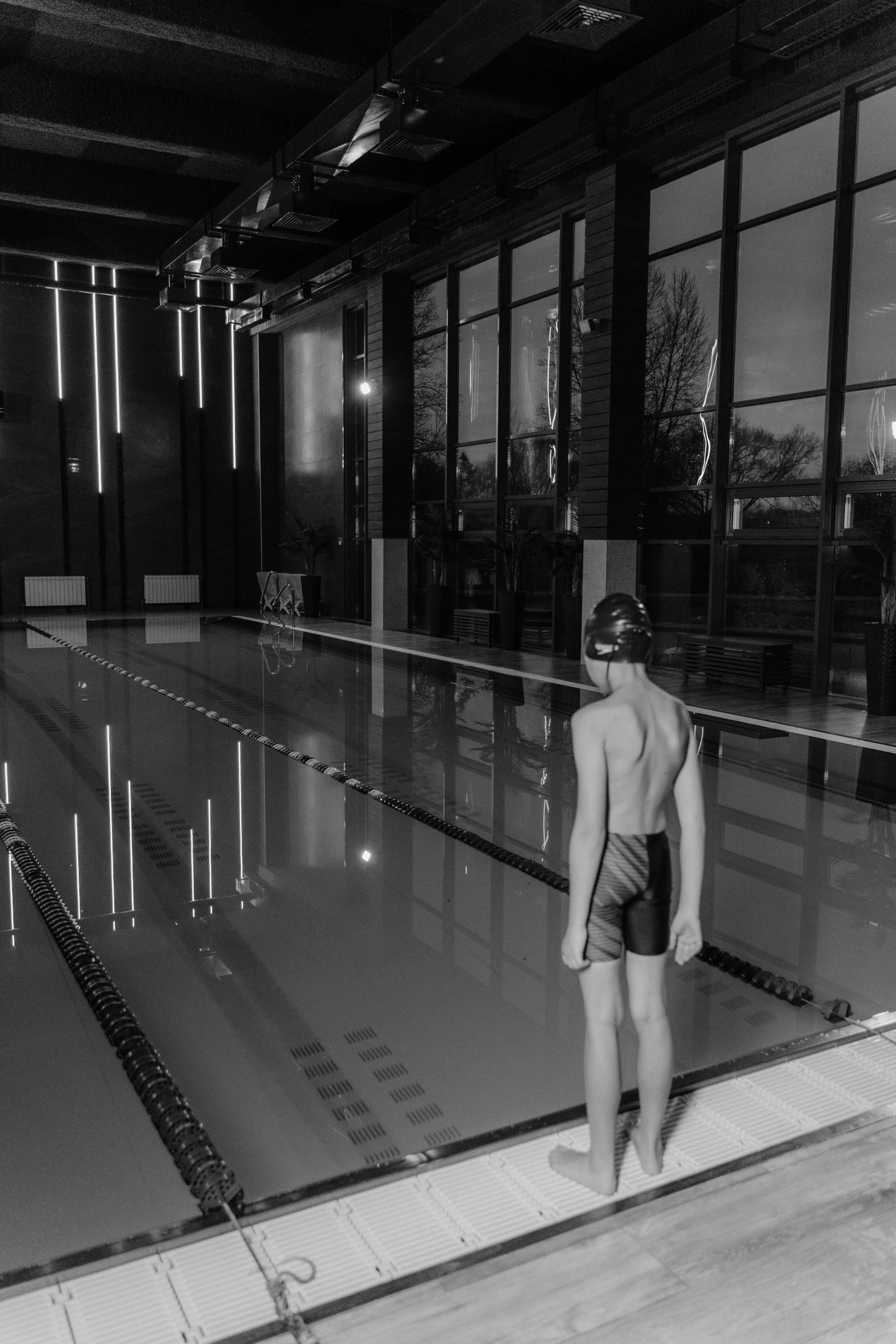 a person standing next to the edge of a pool