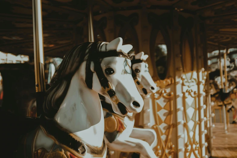 two carousel horses are standing next to each other