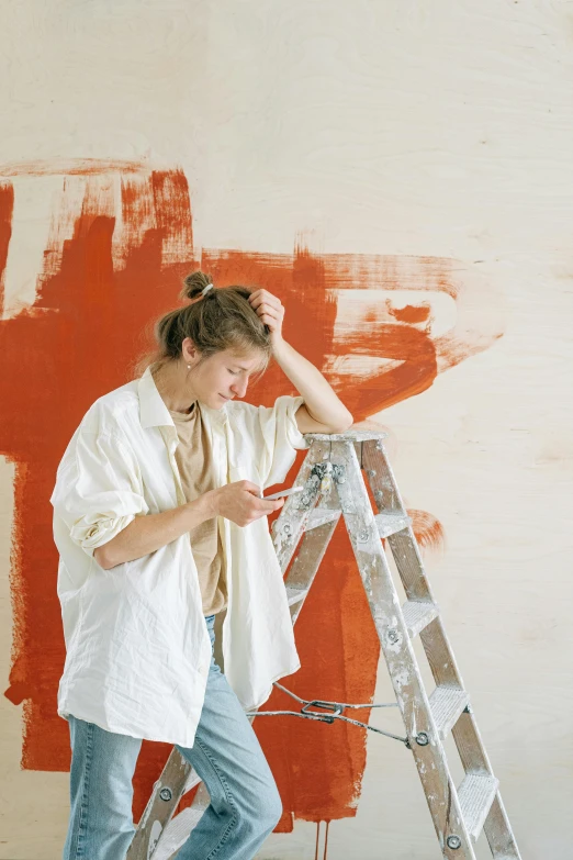 a man in a white shirt is painting a wall