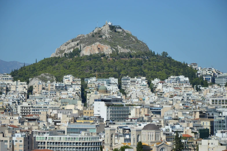 a city filled with tall buildings and a mountain