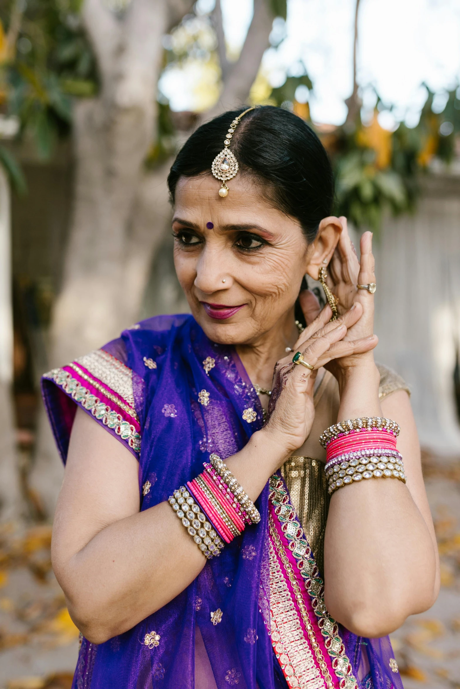 woman in a purple colored dress wearing jewellery