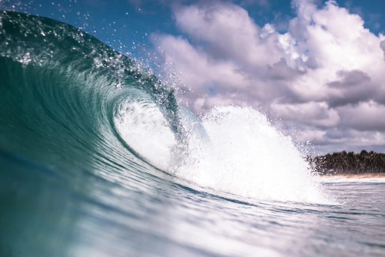 a large wave is breaking over the beach