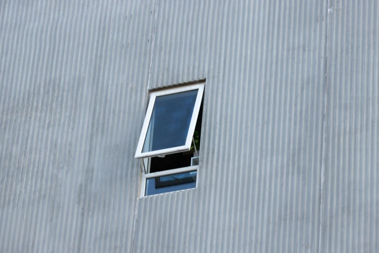 an open window that is on the side of a building