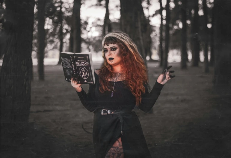 a woman is dressed in black and holding an album