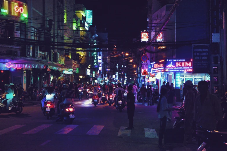 people are walking and riding scooters on the street