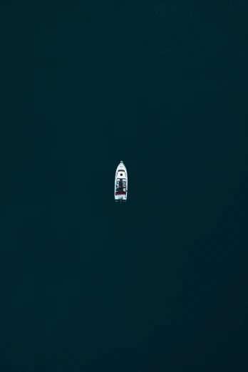 a boat floats on the water next to an object