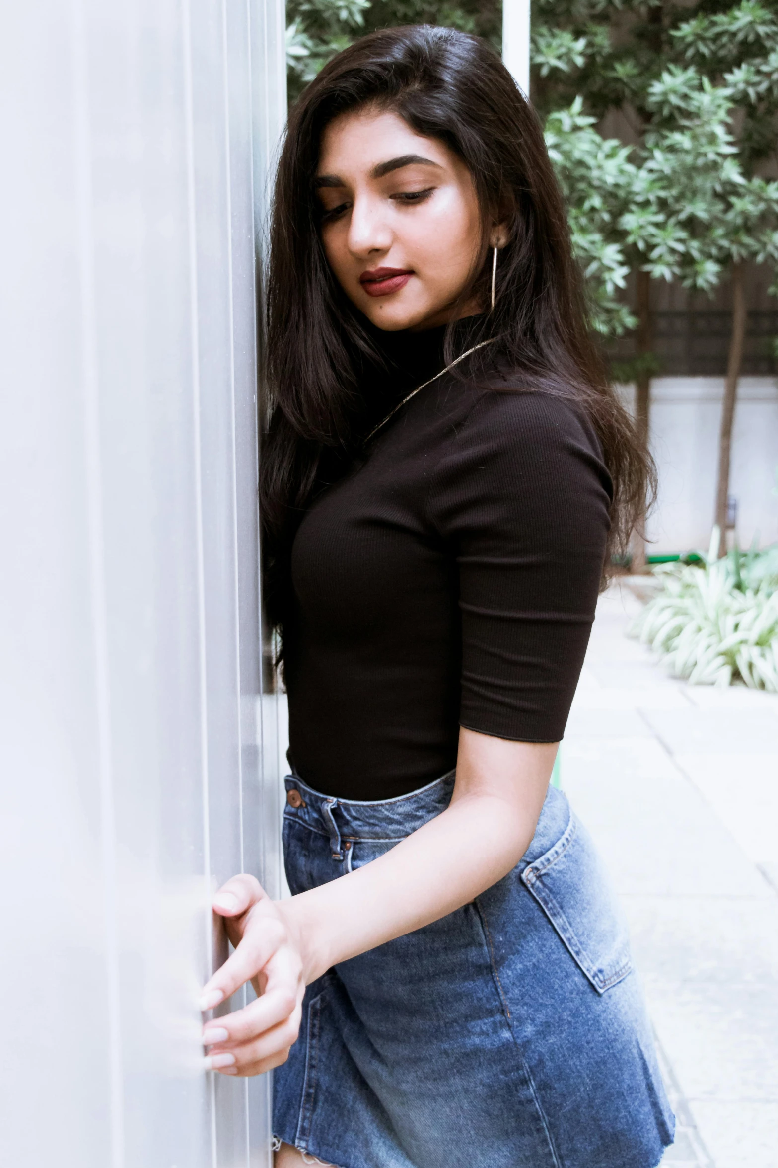 a woman with long dark hair wearing a black top