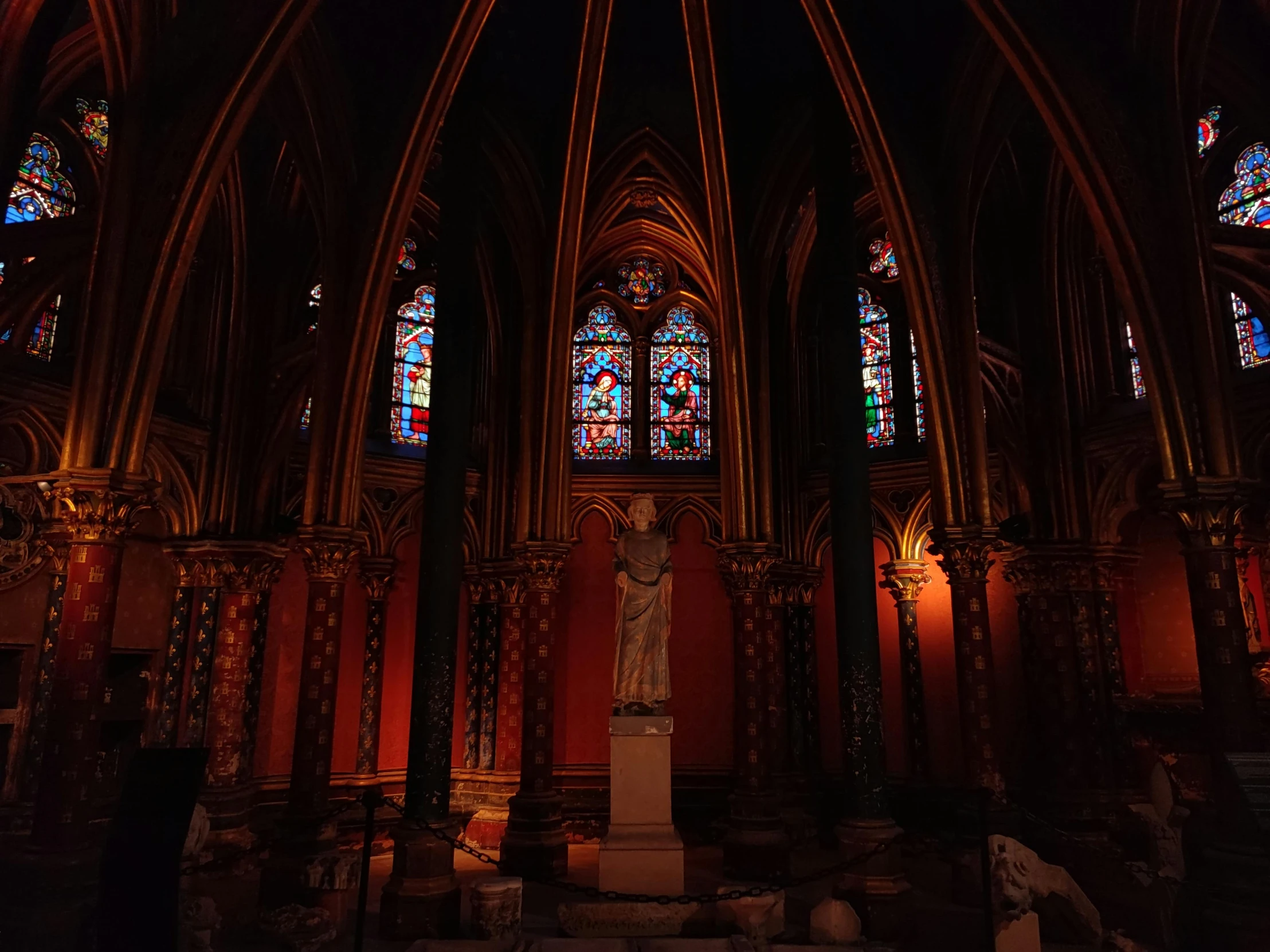 the interior of a large cathedral with multiple stained glass windows