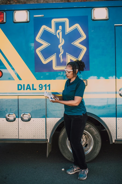 a woman stands in front of a medical bus