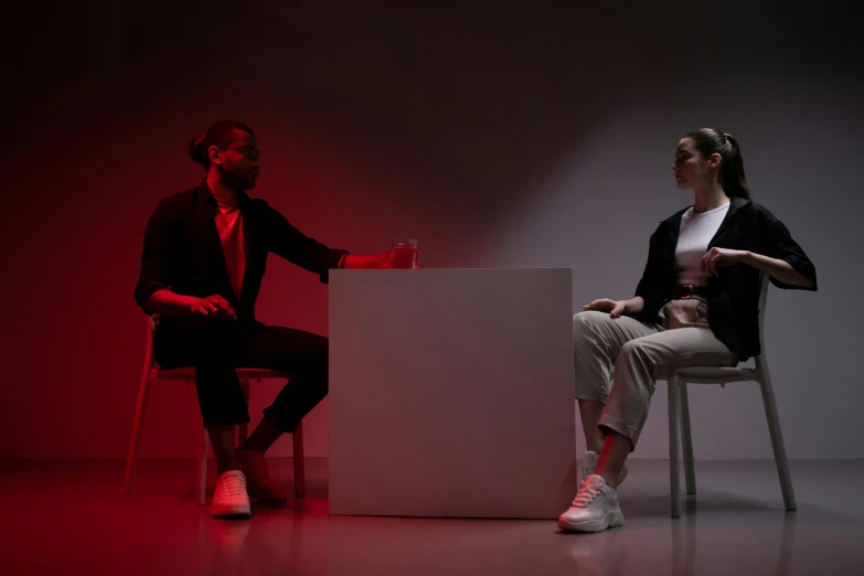 two people in black and white sitting on chair