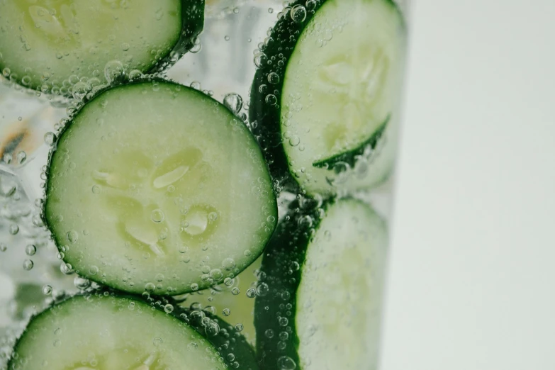 a drink with cucumbers floating inside